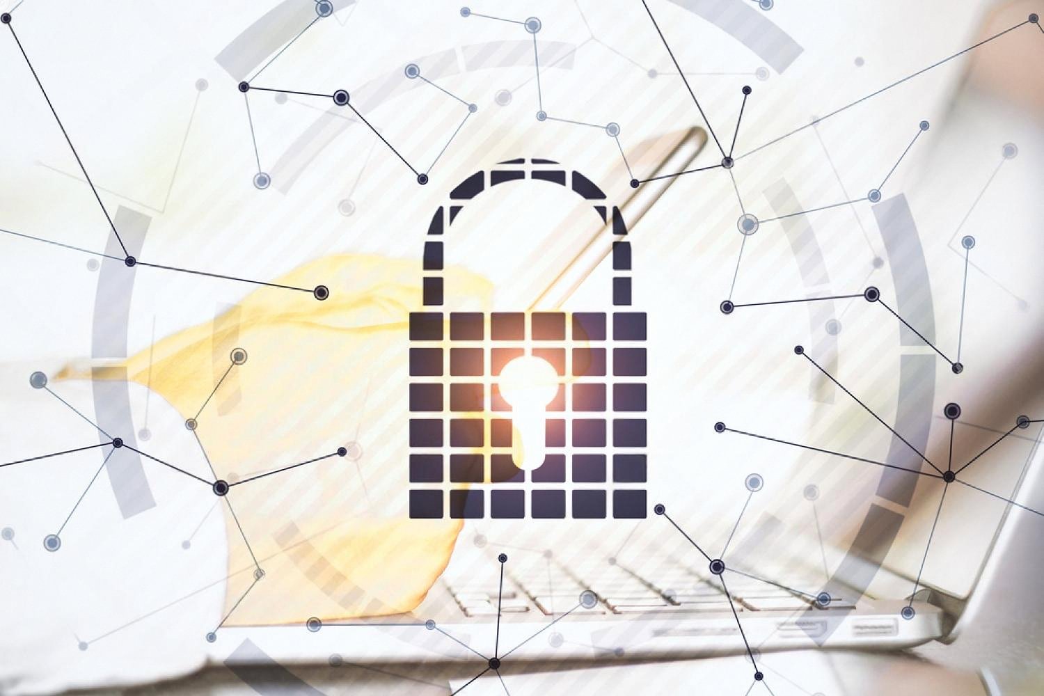 Padlock icon overlaid on a laptop keyboard representing a company cybersecurity check